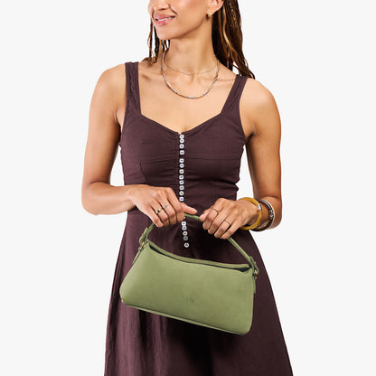 Laurel | Model holding a light green bowler style hand bag