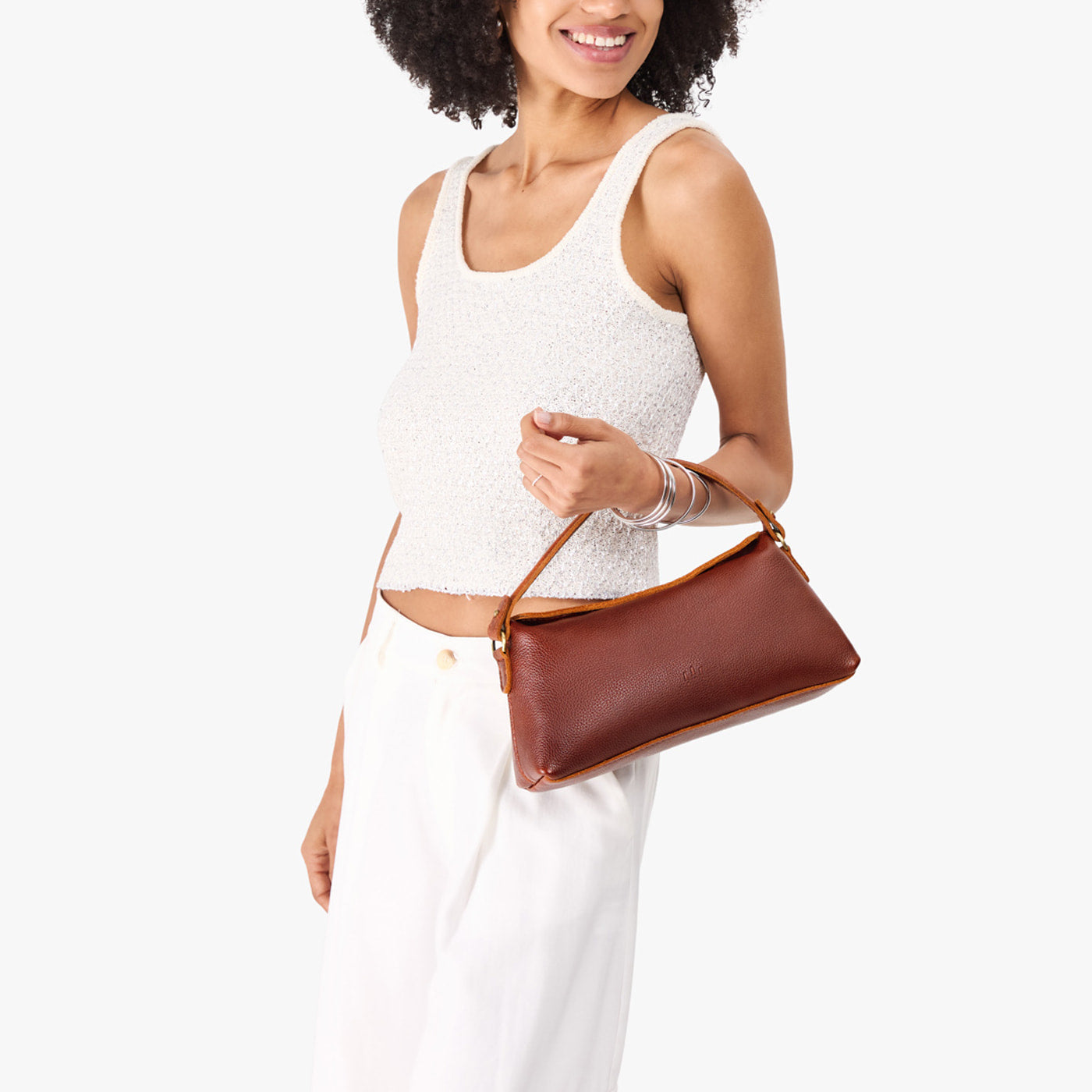 Nutmeg | Model holding a brown colored bowler style hand bag