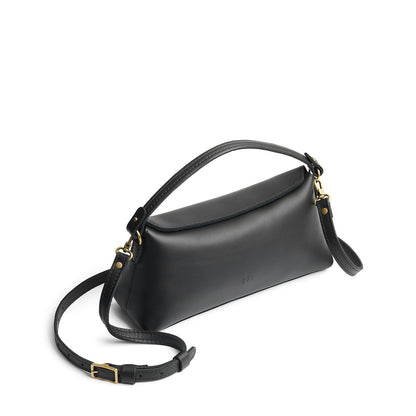 Black | Leather bowler bag with magnetic closure against a white background