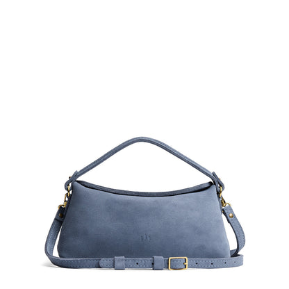Denim | Leather bowler bag with magnetic closure against a white background