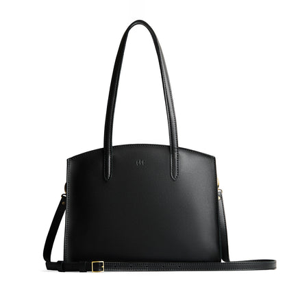 Black*Large | Leather tote bag with handles, adjustable crossbody strap, zipper top, and two back pockets