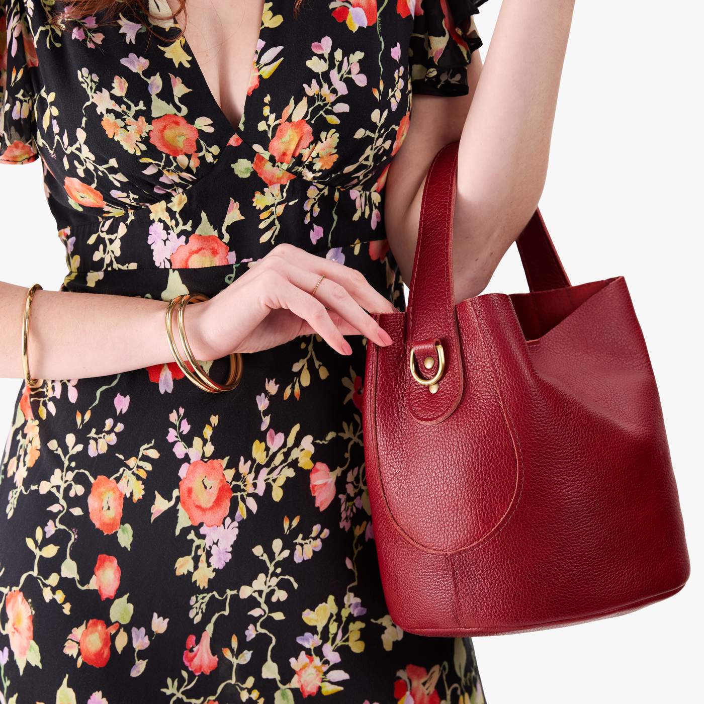 Chili Red*Large | Model holding symmetrical bucket bag with handle, latch closure, and removable crossbody strap