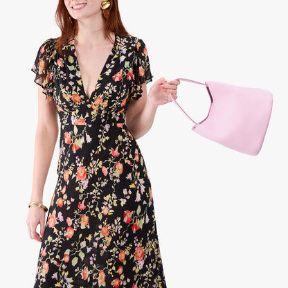Pinkaboo*Large | Model holding symmetrical bucket bag with handle, latch closure, and removable crossbody strap