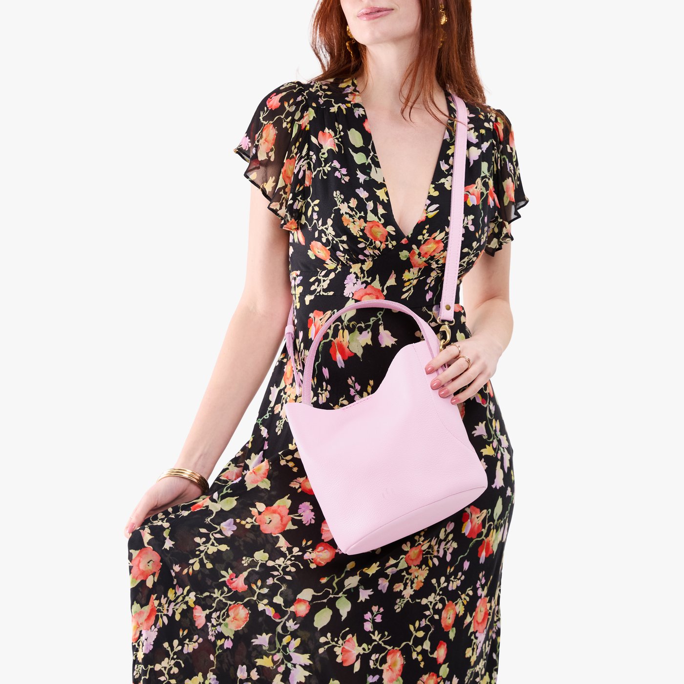 Pinkaboo*Large | Model holding symmetrical bucket bag with handle, latch closure, and removable crossbody strap