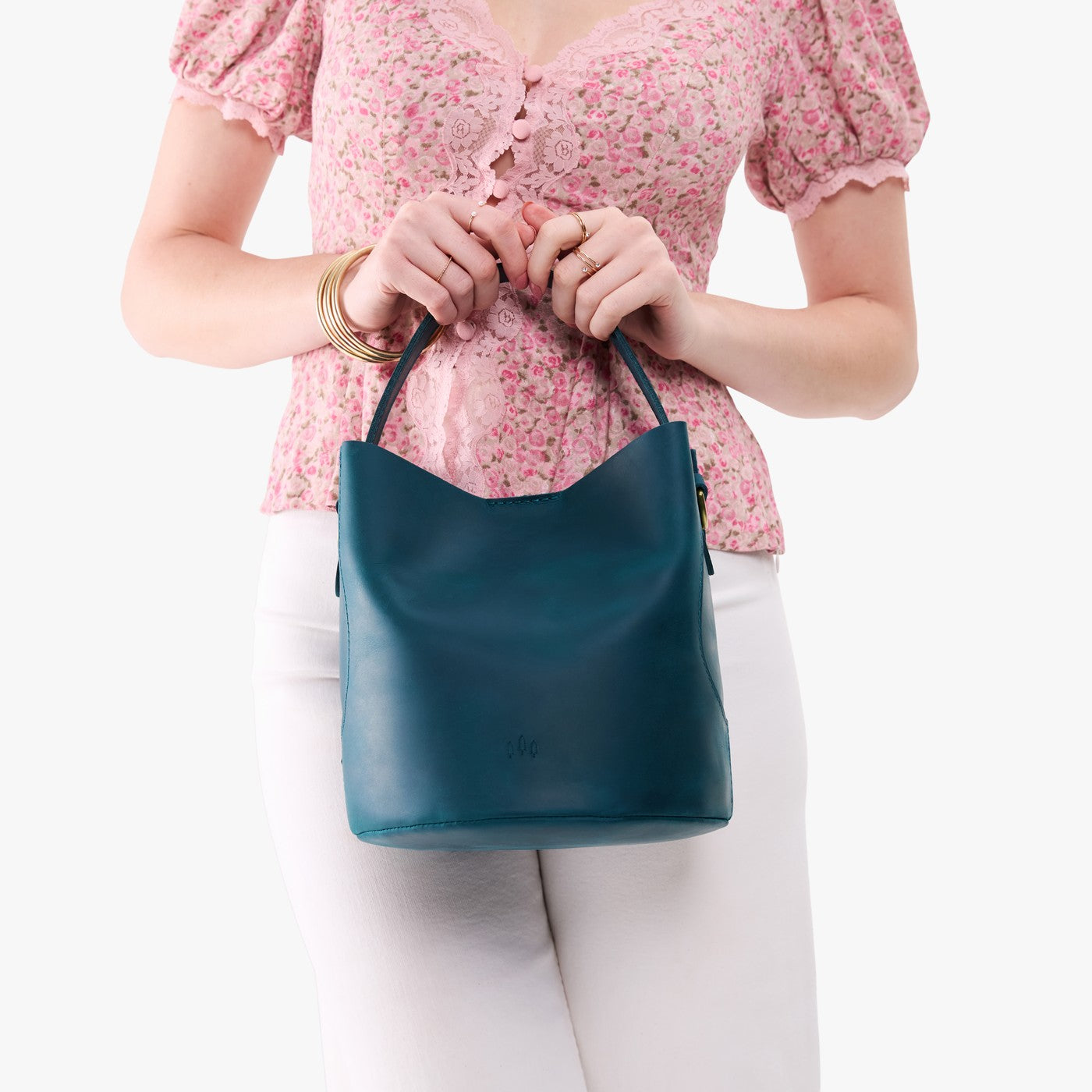 Westward Blue*Large | Model holding symmetrical bucket bag with handle, latch closure, and removable crossbody strap