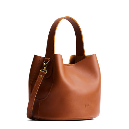 Honey*Small | Symmetrical bucket bag with handle, latch closure, and removable crossbody strap