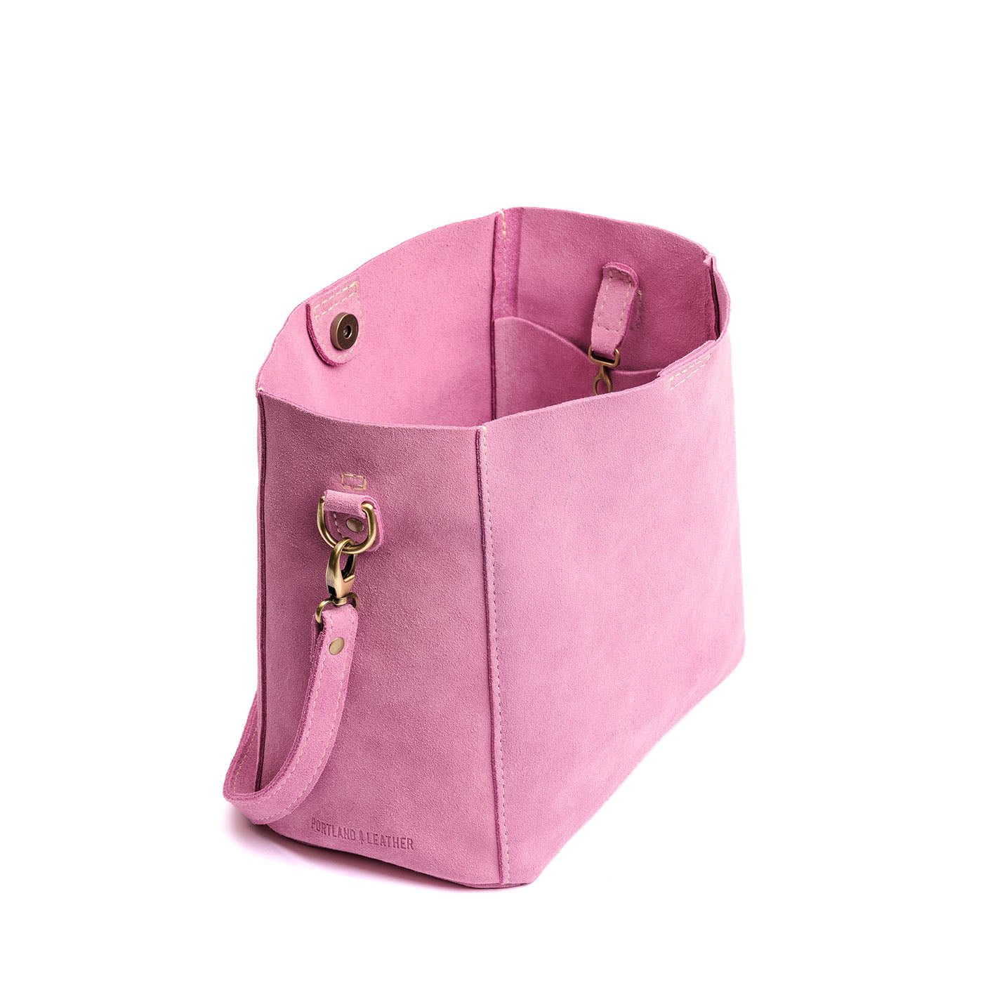 Pink Suede | symmetrical bucket bag with latch closure and removable crossbody strap