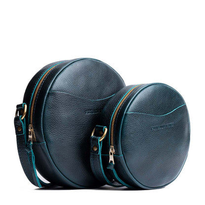 Boreal | Size comparison image of small and large circle shaped crossbody bags with top zipper