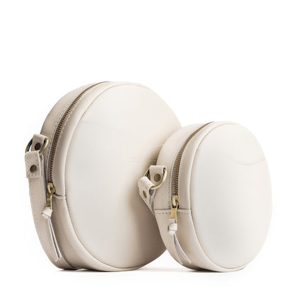 Bone | Size comparison image of small and large circle shaped crossbody bags with top zipper