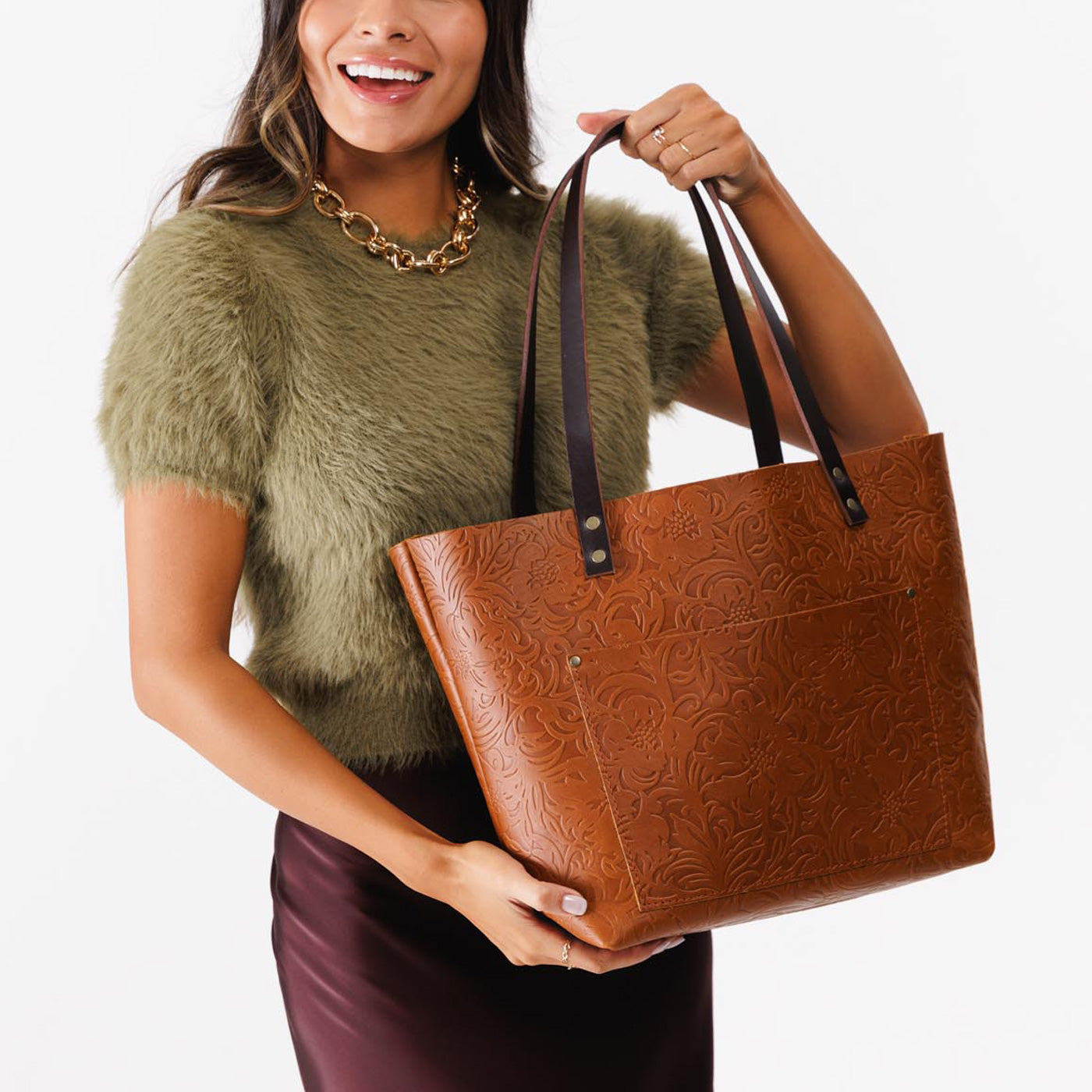 Meadow*Classic | Model holding large zipper leather tote bag with sturdy bridle handles and front pocket
