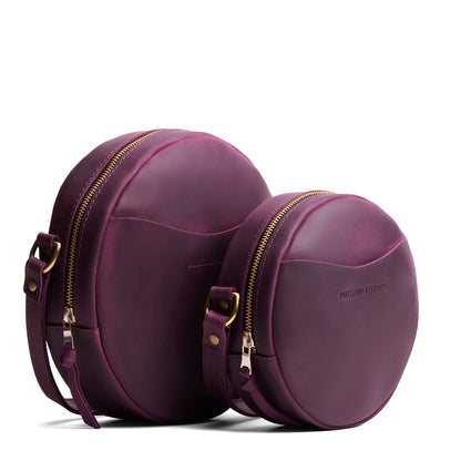 Larkspur | Size comparison image of small and large circle shaped crossbody bags with top zipper