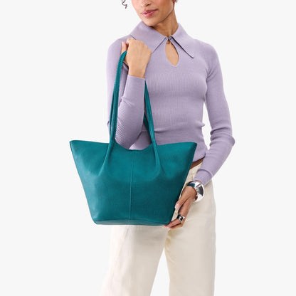 Aquarius*Large | Model wearing lavender sweater and white pants carrying wide bucket shaped tote bag with matching leather handles