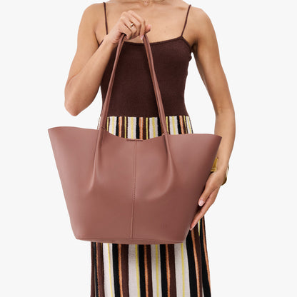 Sunkissed*Oversized | Model holding extra wide bucket shaped tote bag with matching leather handles
