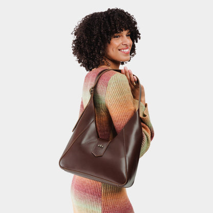 Chocolate Brown | Model wearing structured hobo shoulder bag with adjustable strap and magnetic closure