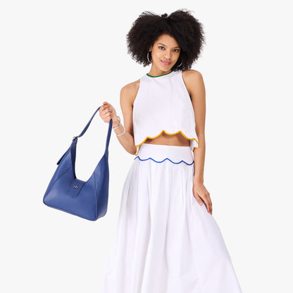 Molino Blue | Model wearing structured hobo shoulder bag with adjustable strap and magnetic closure
