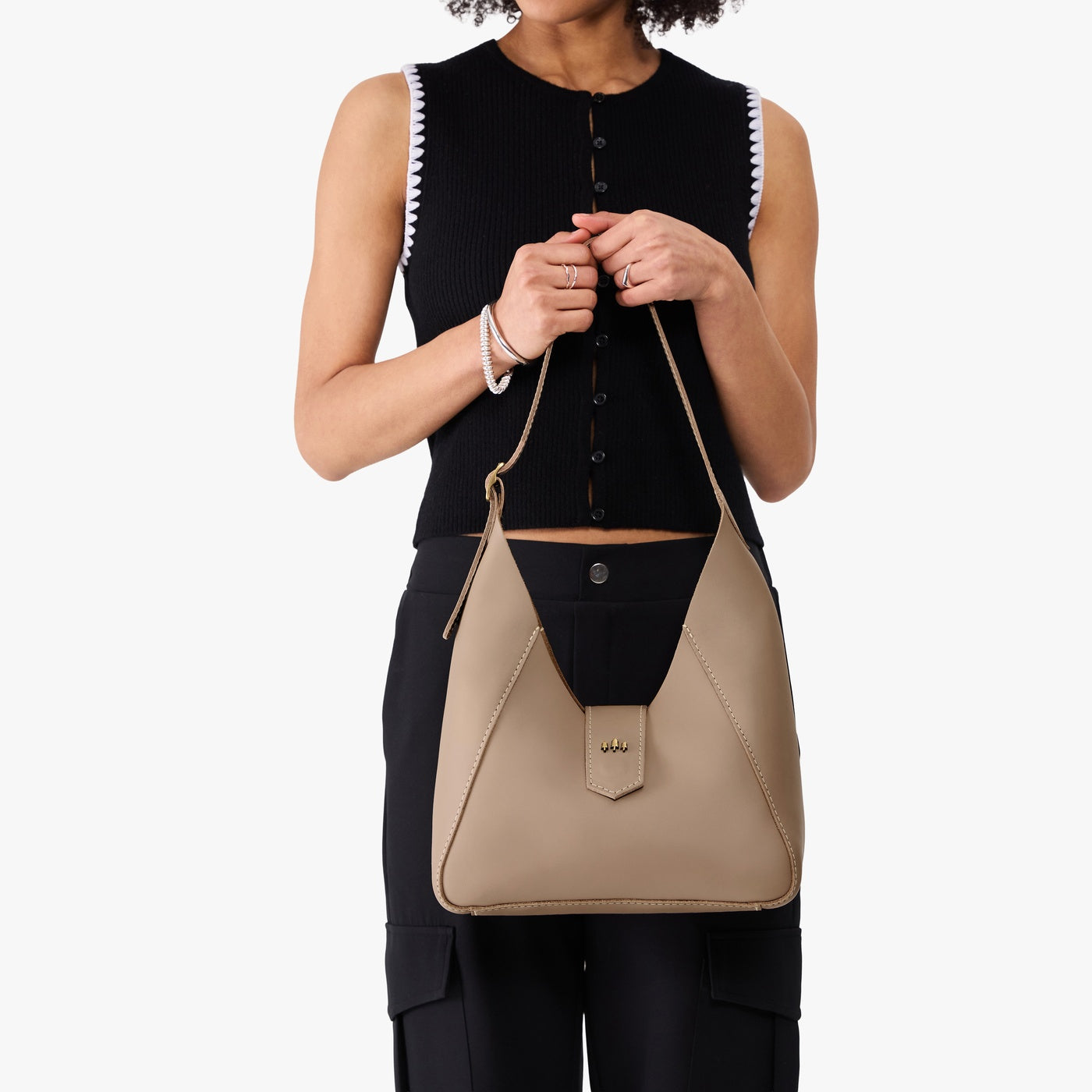 Stone | Model wearing structured hobo shoulder bag with adjustable strap and magnetic closure