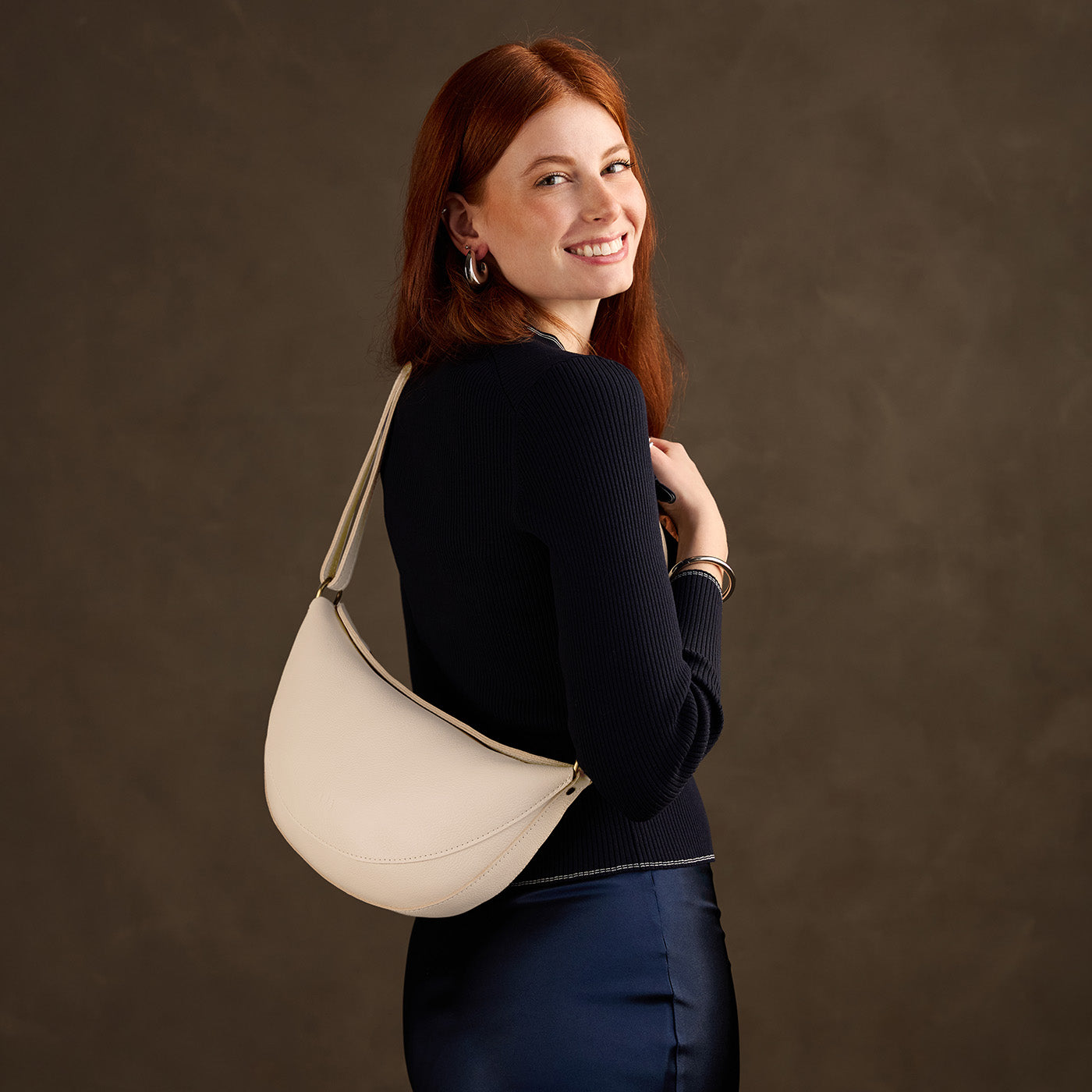 Pebbled Bone*Large | Model wearing half circle shaped sling bag