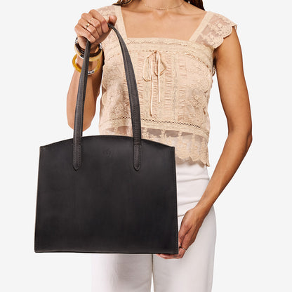 Full Moon*Large | Model carrying leather tote bag with handles, adjustable crossbody strap, and two back pockets