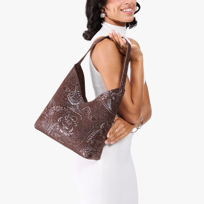 Sepia*Large | Model holding mid-size shoulder bag with magnetic snap closure