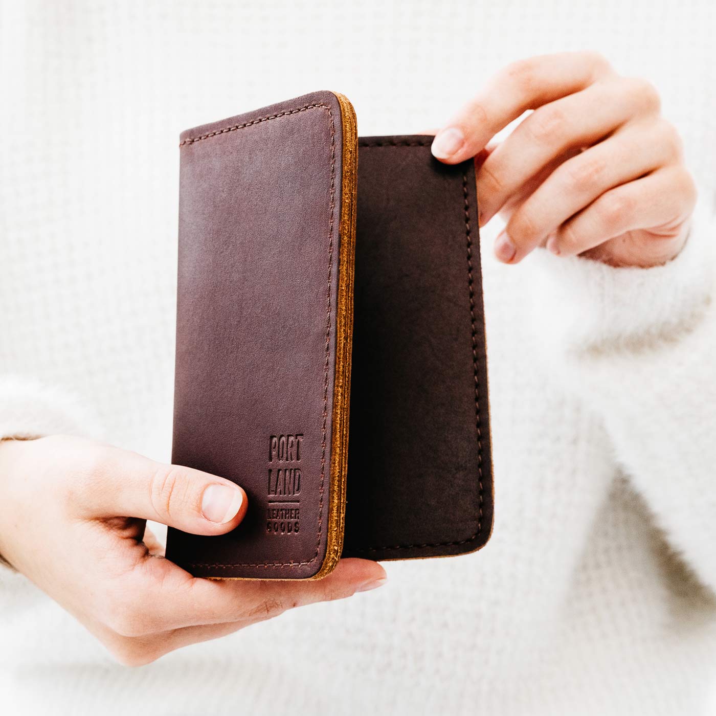 Congac | Model holding leather passport case with PLG logo