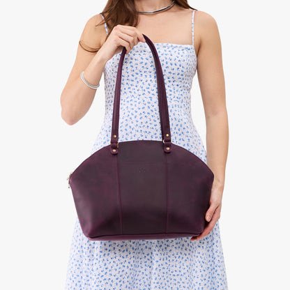 Larkspur*Large | Model holding a half circle crossbody bag with handles and removable crossbody strap
