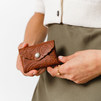 Meadow | Model holding small leather wallet with scalloped edge