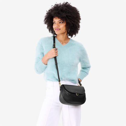 Black*Large | Model wearing a leather Crossbody with a flap and magnetic closure