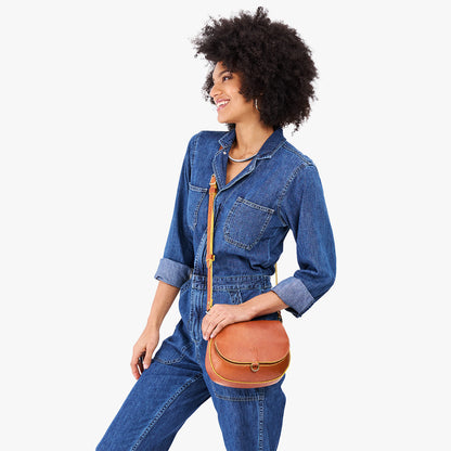 Sienna*Small | Model wearing a petite leather Crossbody with a flap and magnetic closure