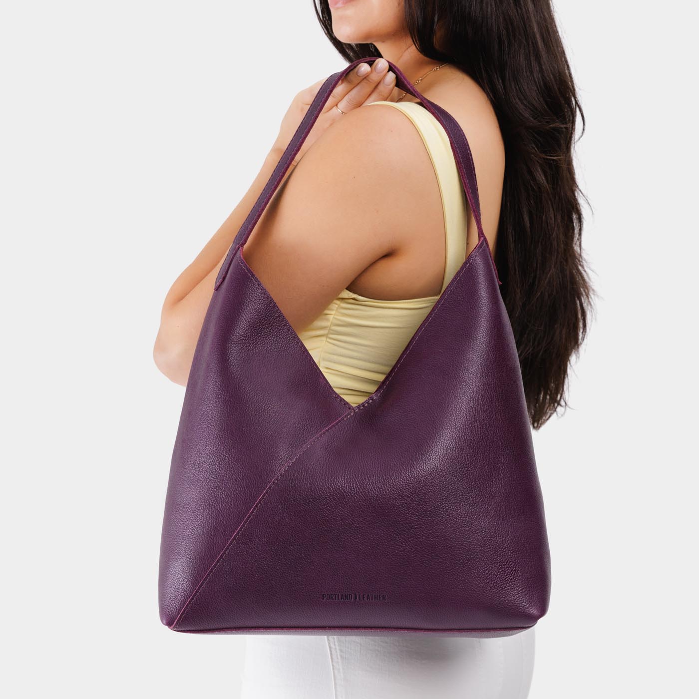 Plum*Oversized | Model wearing large shoulder bag with magnetic snap closure