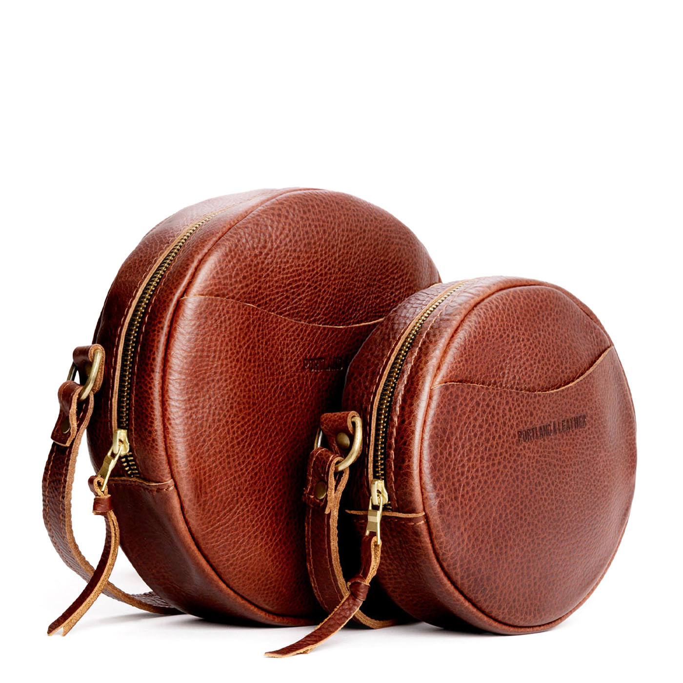 Nutmeg | Size comparison image of small and large circle shaped crossbody bags with top zipper