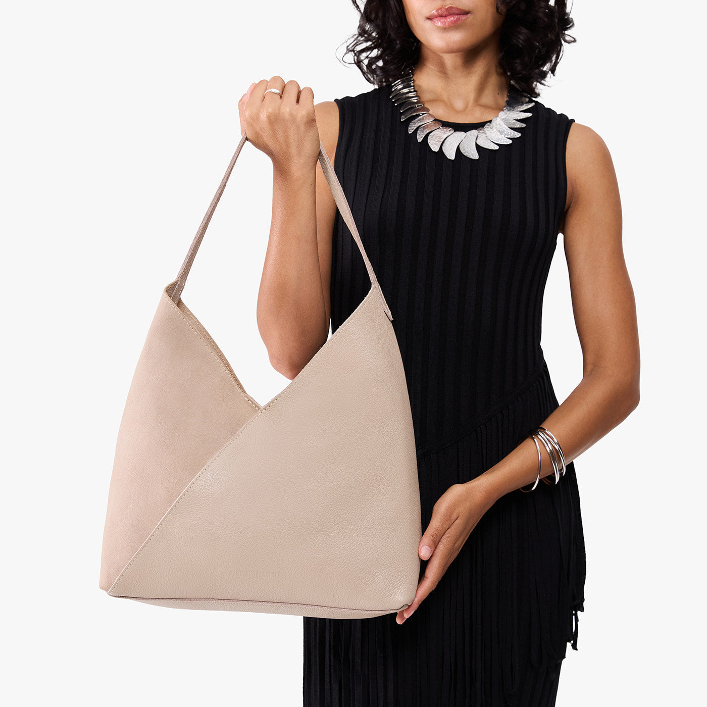 Toasted Oat*Oversized | Model holding large shoulder bag with adjustable strap and magnetic snap closure