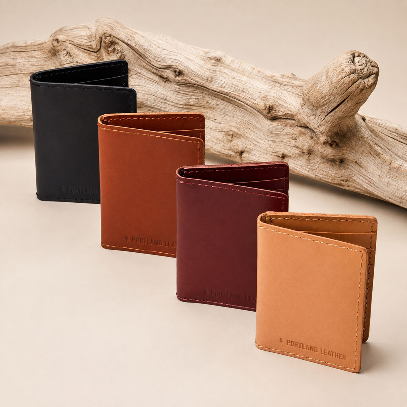 Marrone | Group of wallets in front of a piece of drift wood