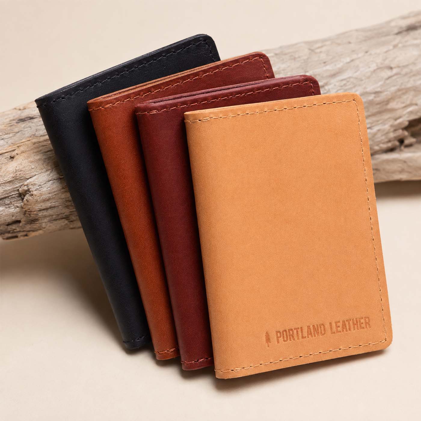 Naturale | Group of wallets staged on a piece of drift wood