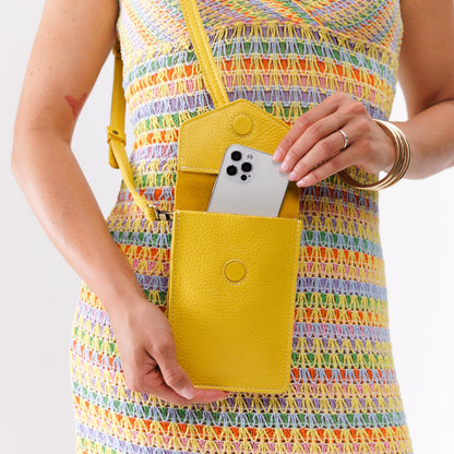 Naples | Model wearing slim, phone-shaped crossbody purse with magnetic closure