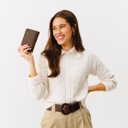 Canyon | Model holding leather passport case with PLG logo