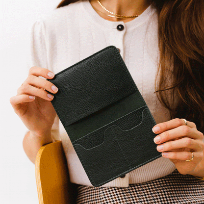 Pebbled--black | Model holding leather passport case with PLG logo