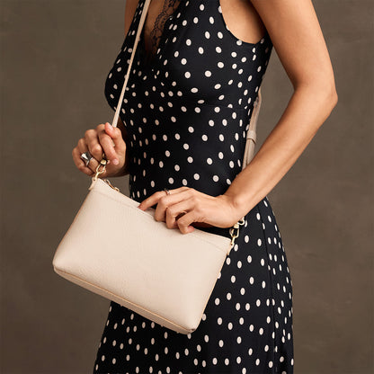 Pebbled Bone*Small | Model wearing a zip top petite crossbody bag with detachable strap