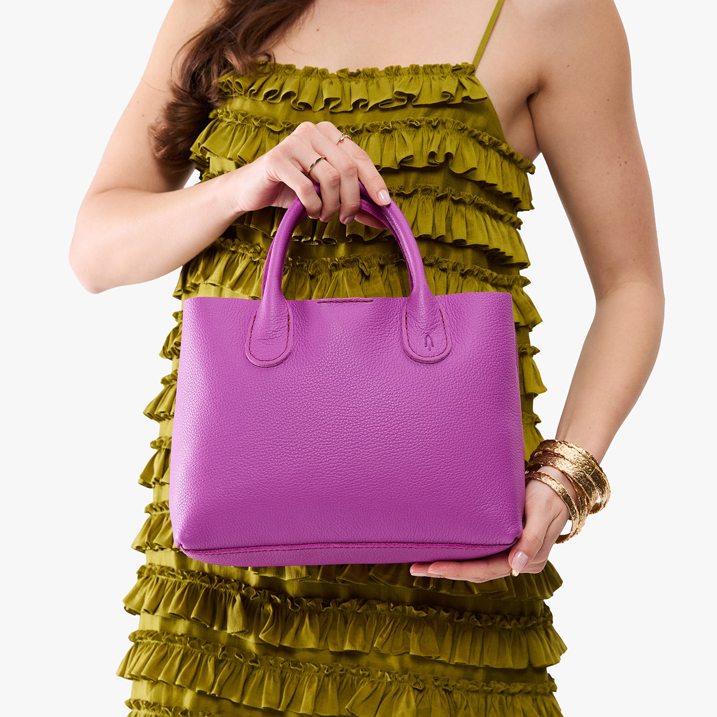 Cattleya*Large | Model holding a mid-size tote purse with structured leather handles and crossbody strap