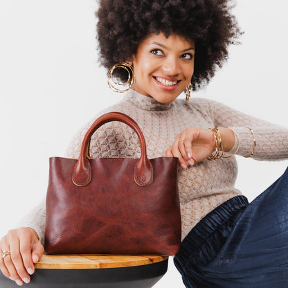 Cinnamon Bear*Large | Model holding mid-size tote purse with structured leather handles and crossbody strap