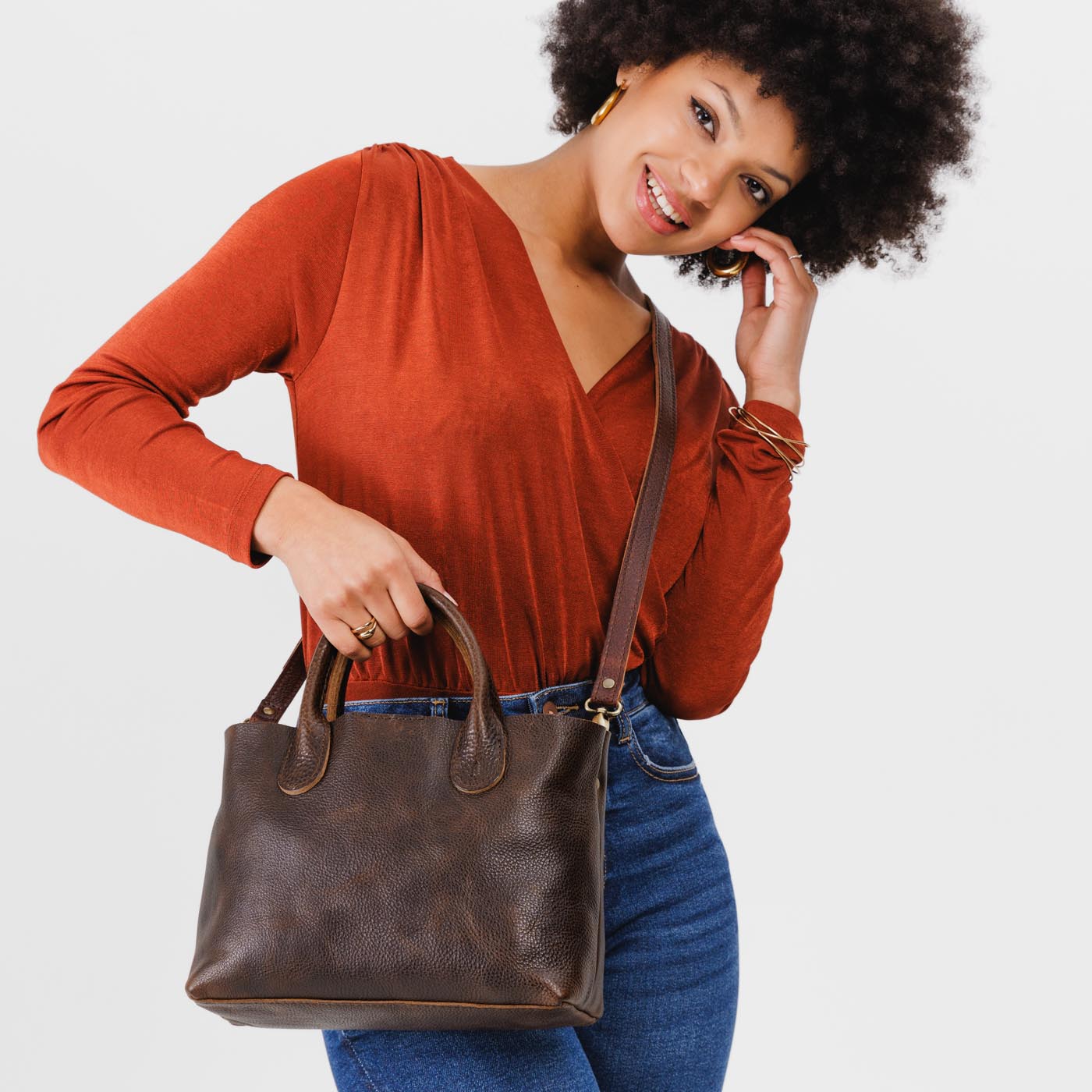 Coldbrew*Large | Model holding mid-size tote purse with structured leather handles and crossbody strap
