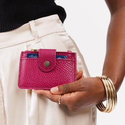 Cosmo | Model holding compact wallet with snap closure and zippered pouch