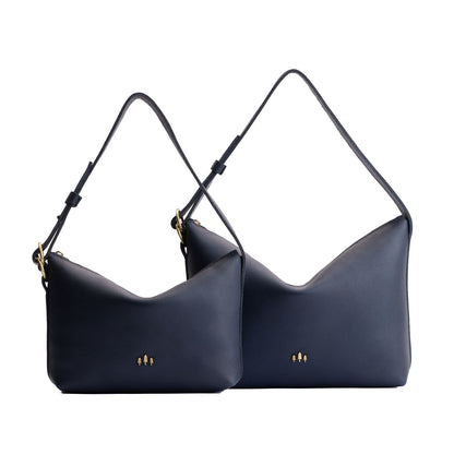 Night Owl | Size comparison shot of small and large slouchy leather shoulder bags with zipper opening and three metal tree emblems