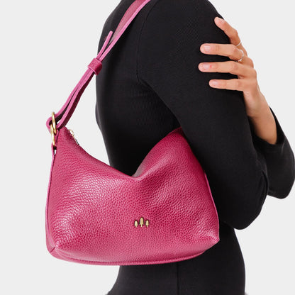 Cosmo*Small | Model wearing petite slouchy leather shoulder bag with zipper opening and three metal tree emblems