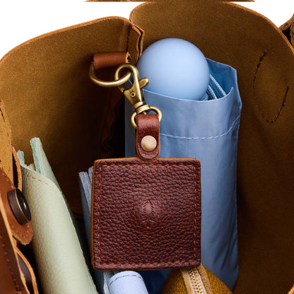 Nutmeg | Square-shaped leather AirTag holder with snap closure and swivel lobster claw clasp
