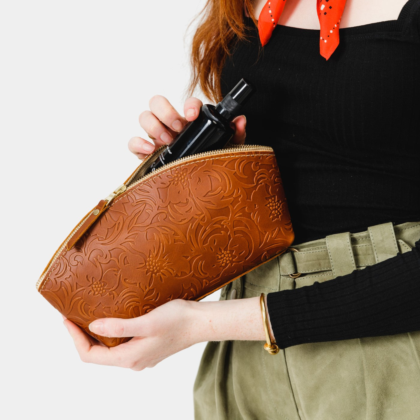 All Color: Meadow | Spacious leather makeup bag with curved seams and top zipper