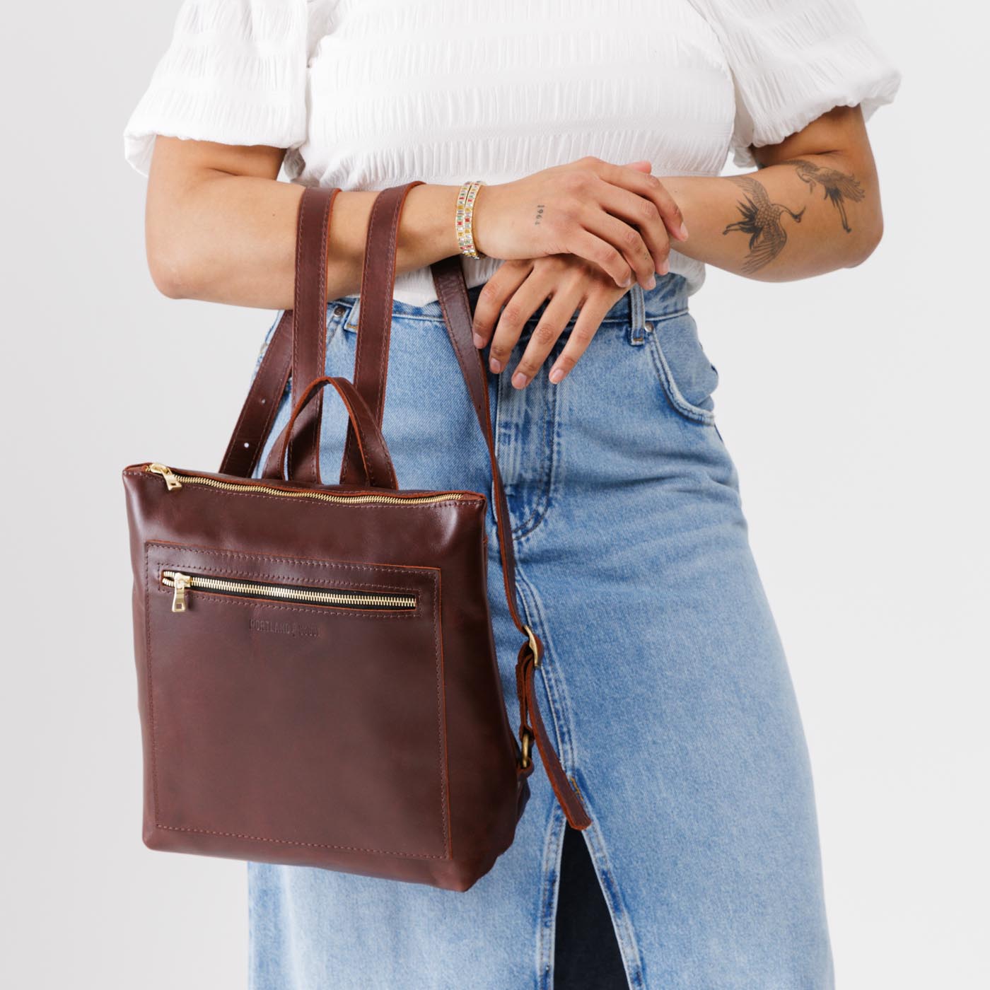 All Color: Cognac*Classic | Model holding square slim leather tote backpack