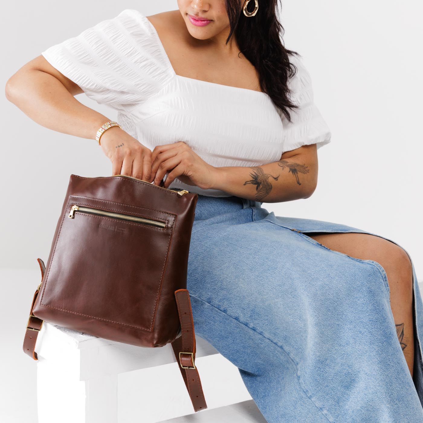 All Color: Cognac*Classic | Model holding square slim leather tote backpack