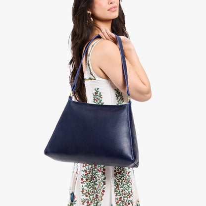 Cobalt*Large | Model carrying large triangular shoulder bag with antiqued brass finished hardware